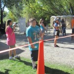 Jeamie cheering runners. Andrew passing out water to finishers
