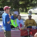 Justin, Linda and Tom(funny hat) far right running the T Shirt table as well as collecting tickets for the Mixing Bowl gift basket