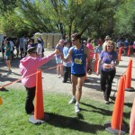 Molly handing medal to marathon finisher